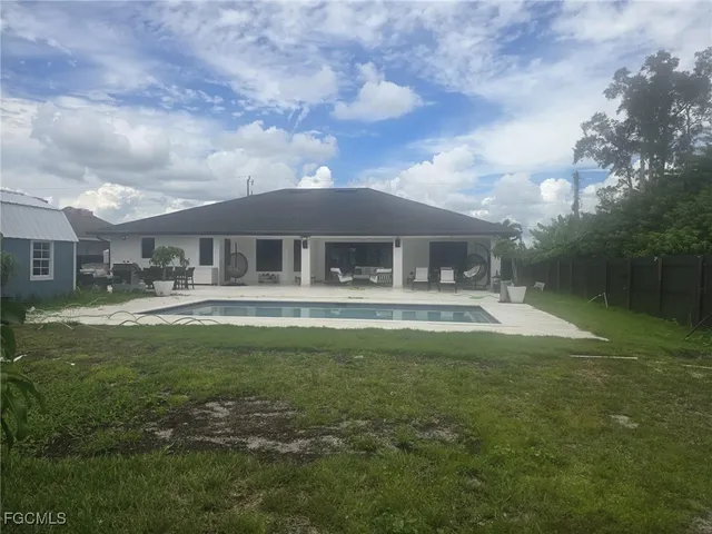 a swimming pool view with a seating space