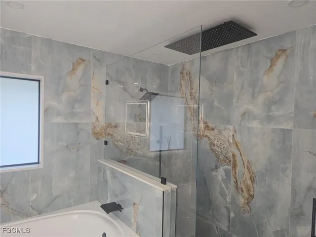 a bathroom with a shower and a toilet