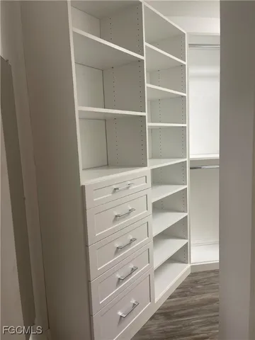 a view of walk in closet with empty racks
