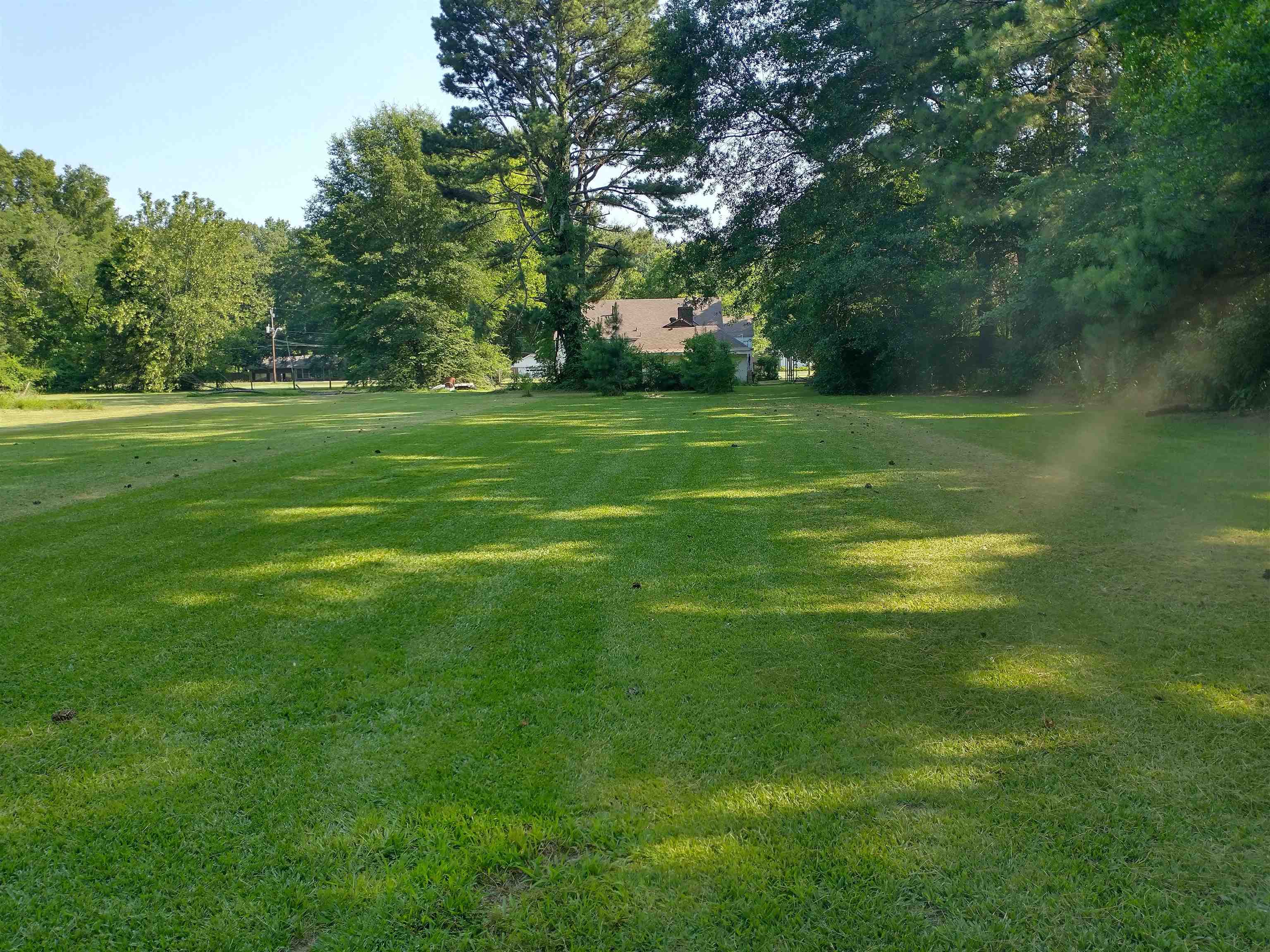 5580 Crestview Road Memphis, TN 38134 - Photo 13 of 15 a view of a grassy field with trees