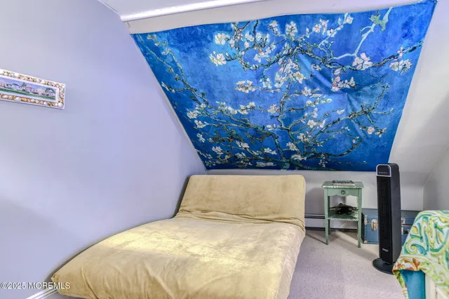 a bed sitting in a bedroom next to a window