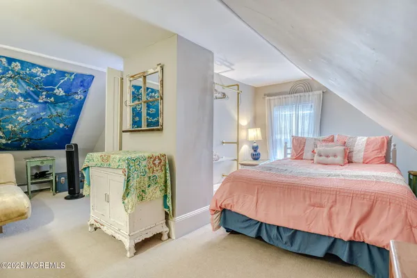 a bedroom with a bed and a mirror