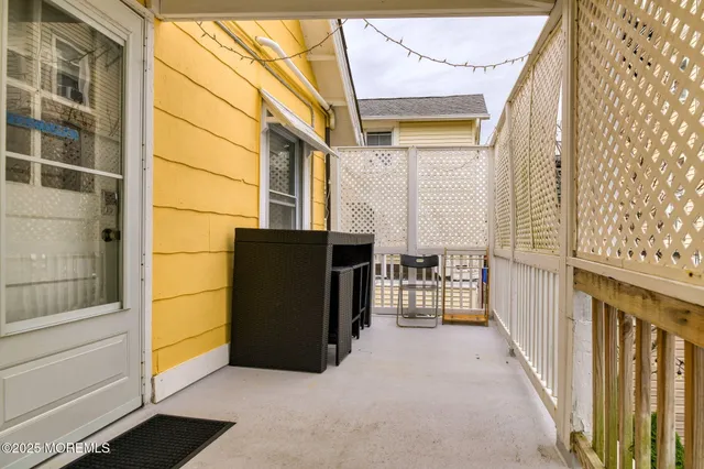 a view of a porch with wooden floor and iron stairs
