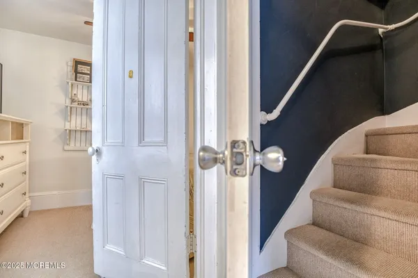 a view of a porch with wooden floor and iron stairs