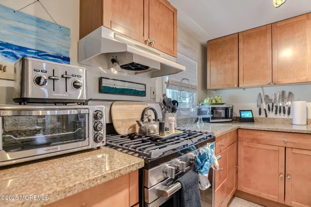 a kitchen with stainless steel appliances granite countertop a stove and a sink