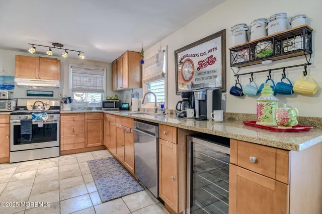 a kitchen with stainless steel appliances granite countertop a stove sink and cabinets