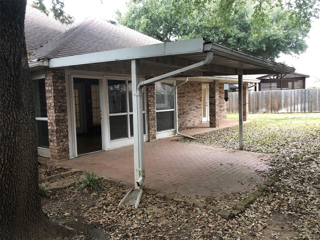 5311 Altacrest Court Grapevine, TX 76051 - Photo 10 of 11 a backyard of a house with barbeque oven table and chairs