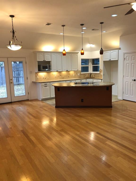 5311 Altacrest Court Grapevine, TX 76051 - Photo 3 of 11 a large kitchen with stainless steel appliances a large counter top a stove a sink dishwasher and a wooden floors