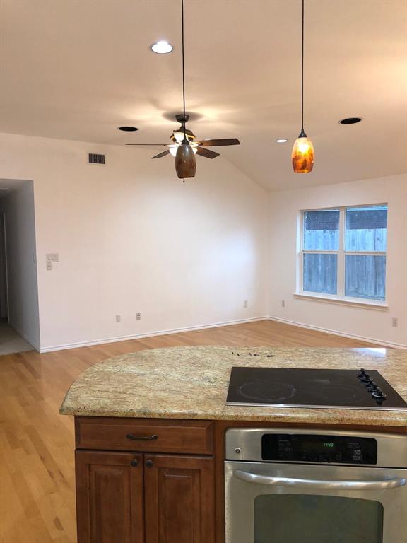 5311 Altacrest Court Grapevine, TX 76051 - Photo 11 of 11 a kitchen with a stove cabinets and wooden floor