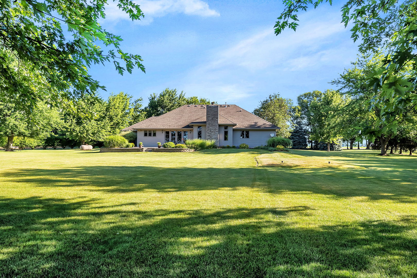 365 Nelson Road Morris, IL 60450 - Photo 38 of 46 a view of swimming pool with lawn chairs and large trees