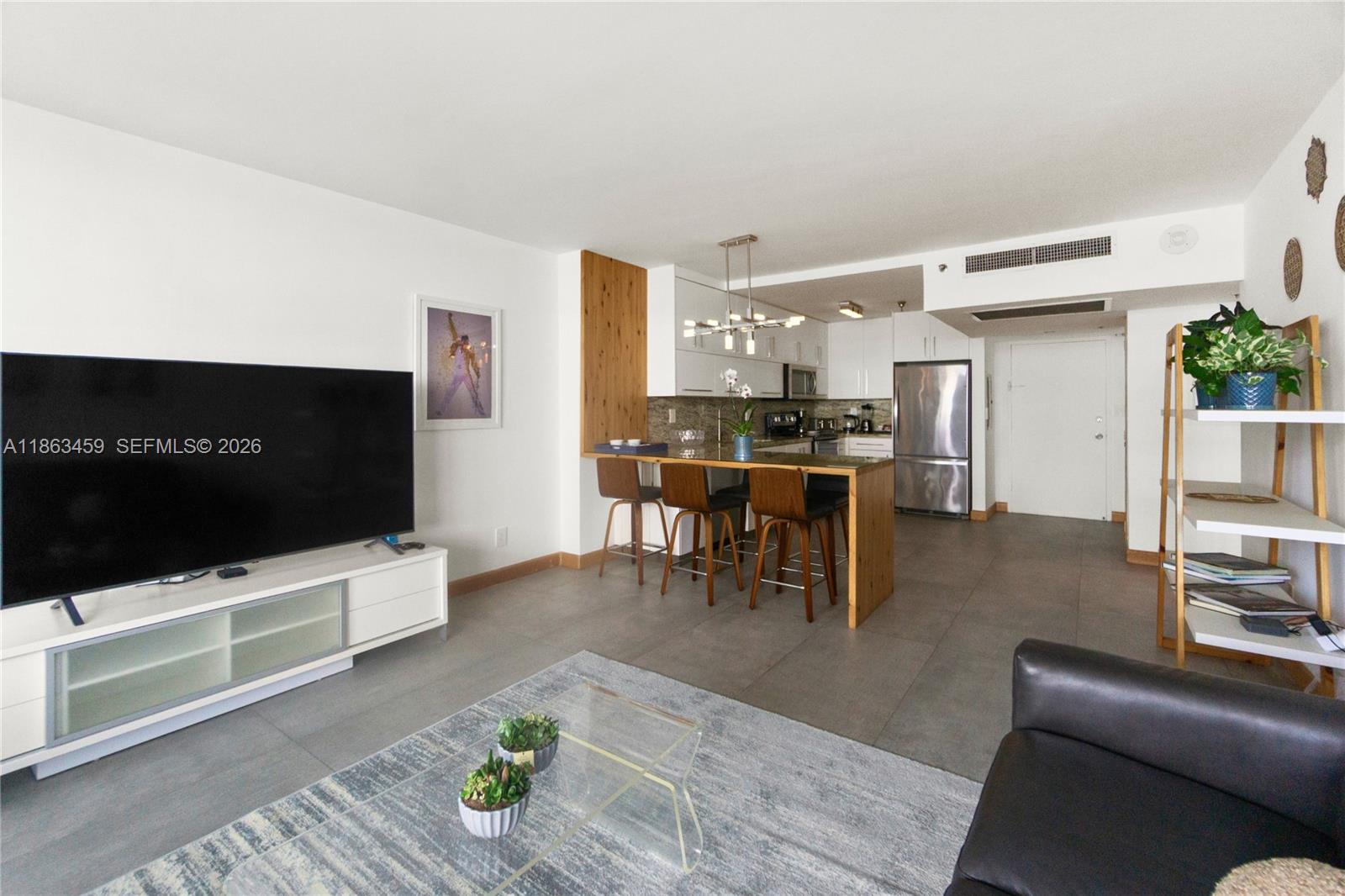 100 Lincoln Road, Unit 1635 Miami Beach, FL 33139 - Photo 11 of 38 a living room with furniture and a flat screen tv
