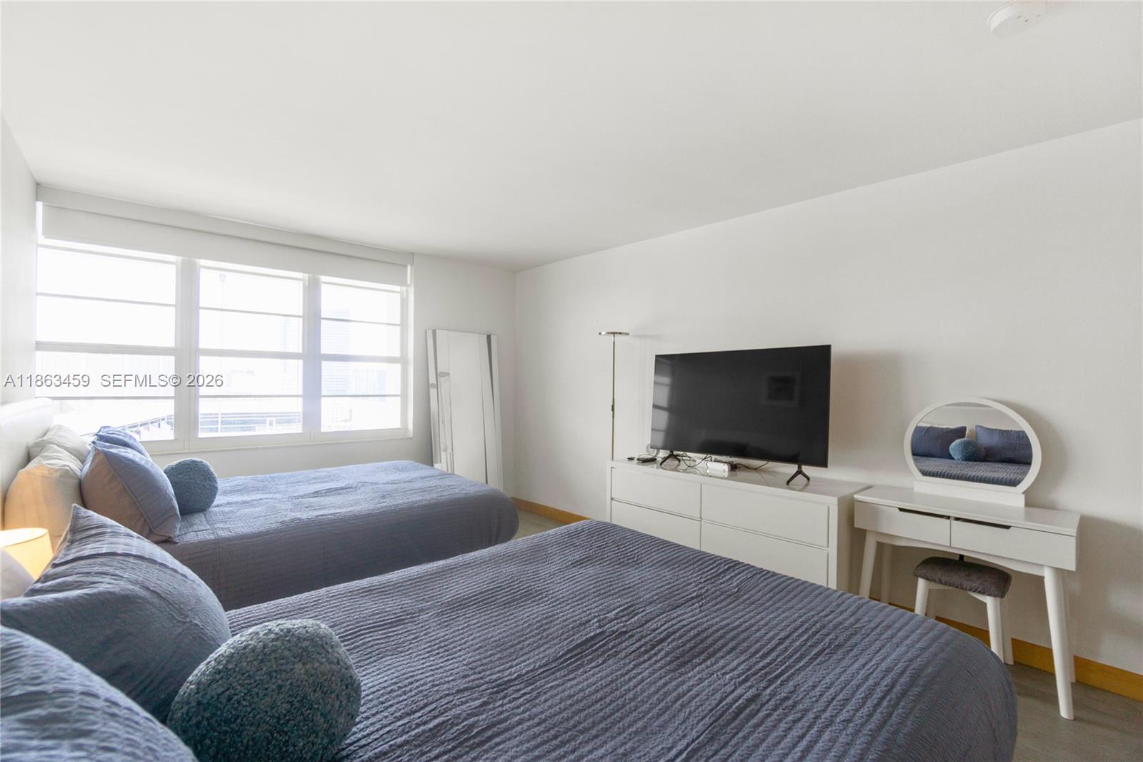 100 Lincoln Road, Unit 1635 Miami Beach, FL 33139 - Photo 19 of 38 a bedroom with a bed and a flat screen tv