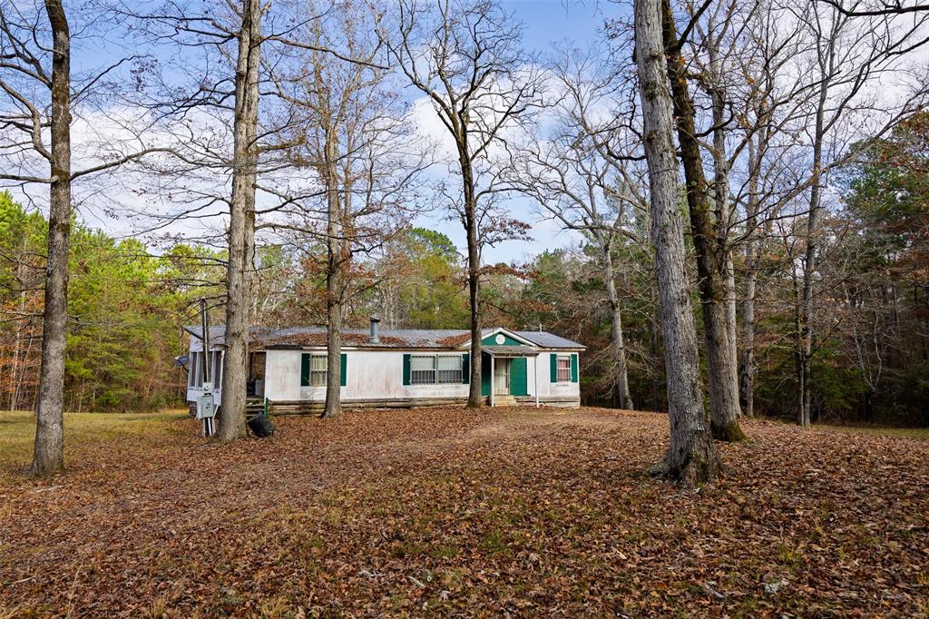 0 County Road 511 Kennard, TX 75847 - Photo 12 of 40 a white house that has a tree in front of it