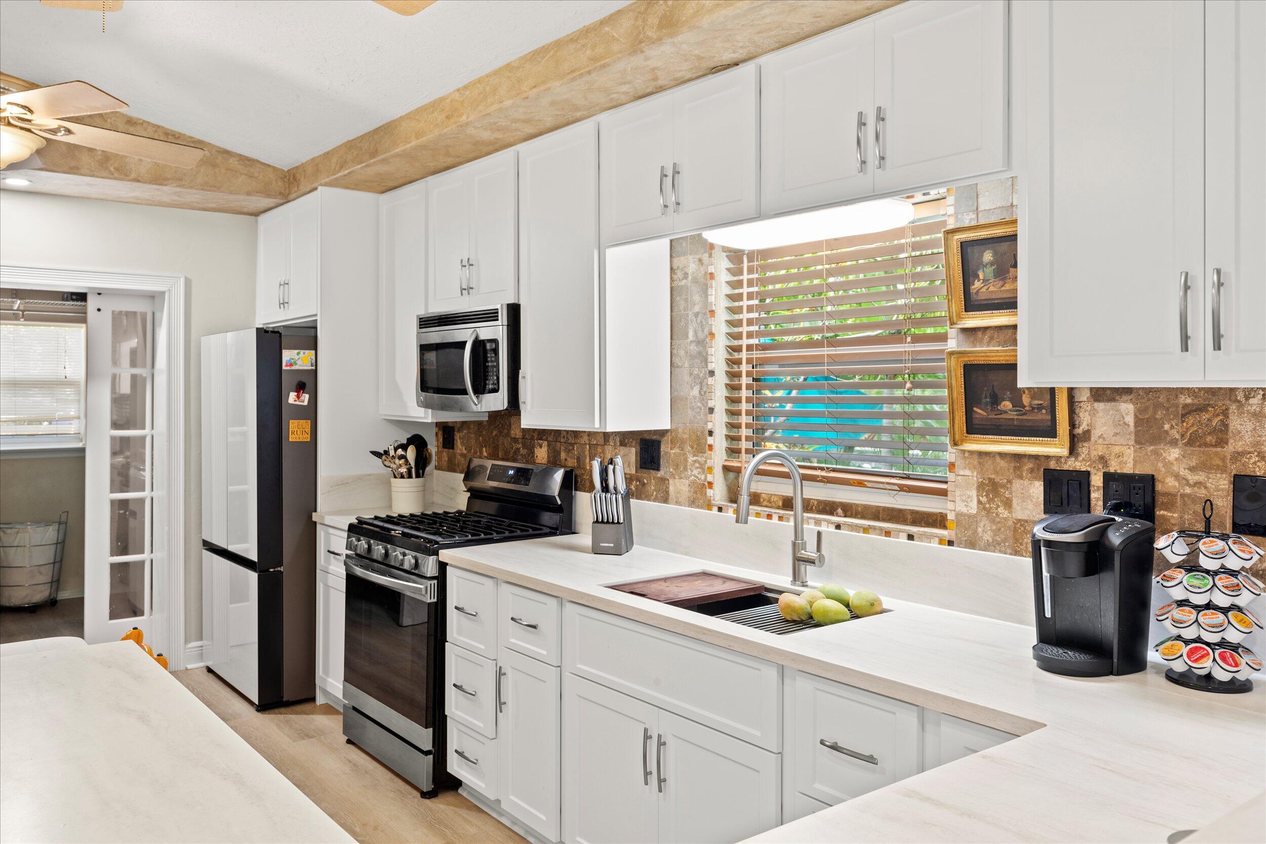 1320 6th Street Key West, FL 33040 - Photo 23 of 61 a kitchen with a sink stove and refrigerator