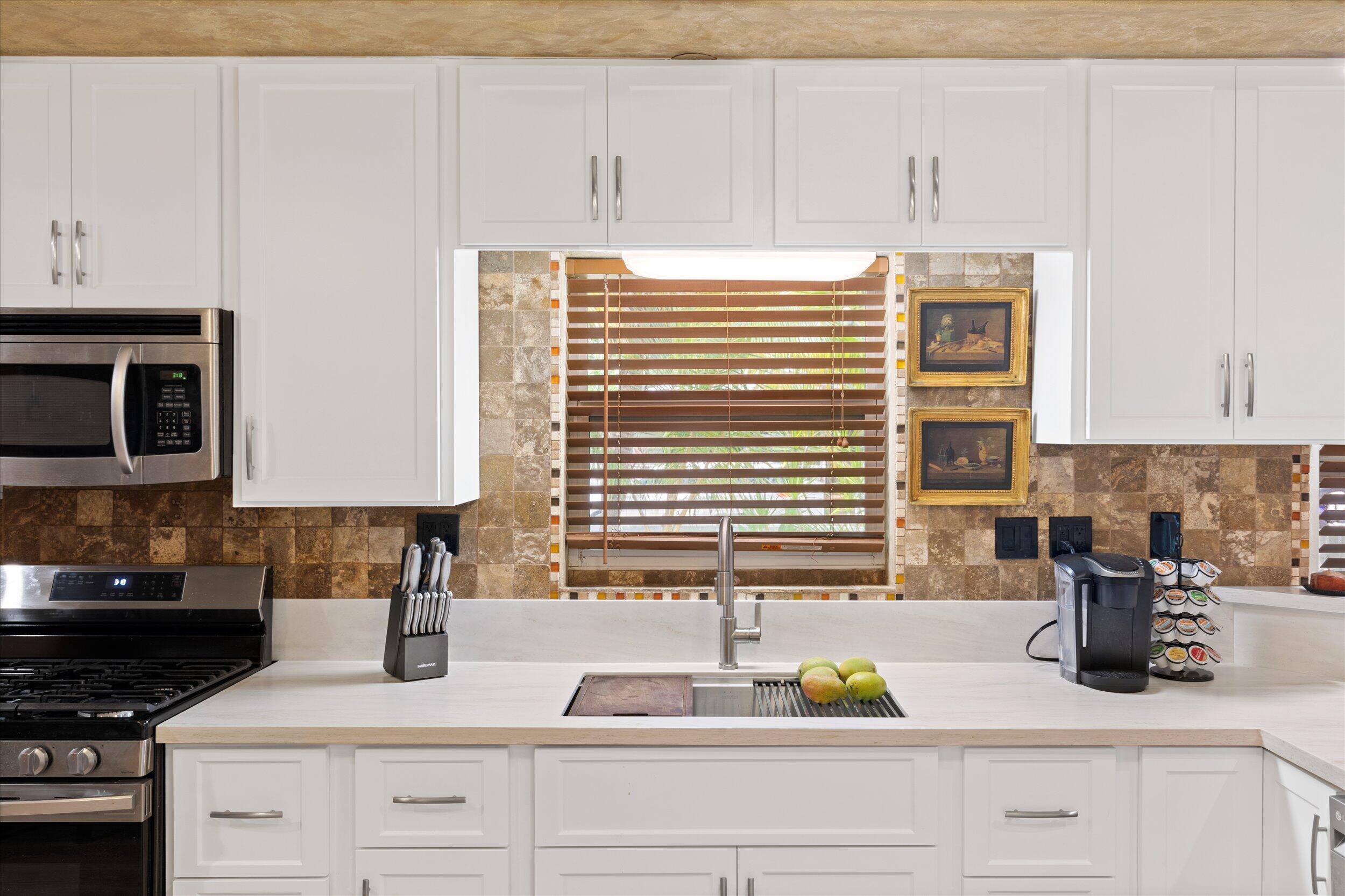 1320 6th Street Key West, FL 33040 - Photo 25 of 61 a kitchen with granite countertop a sink white cabinets and a window