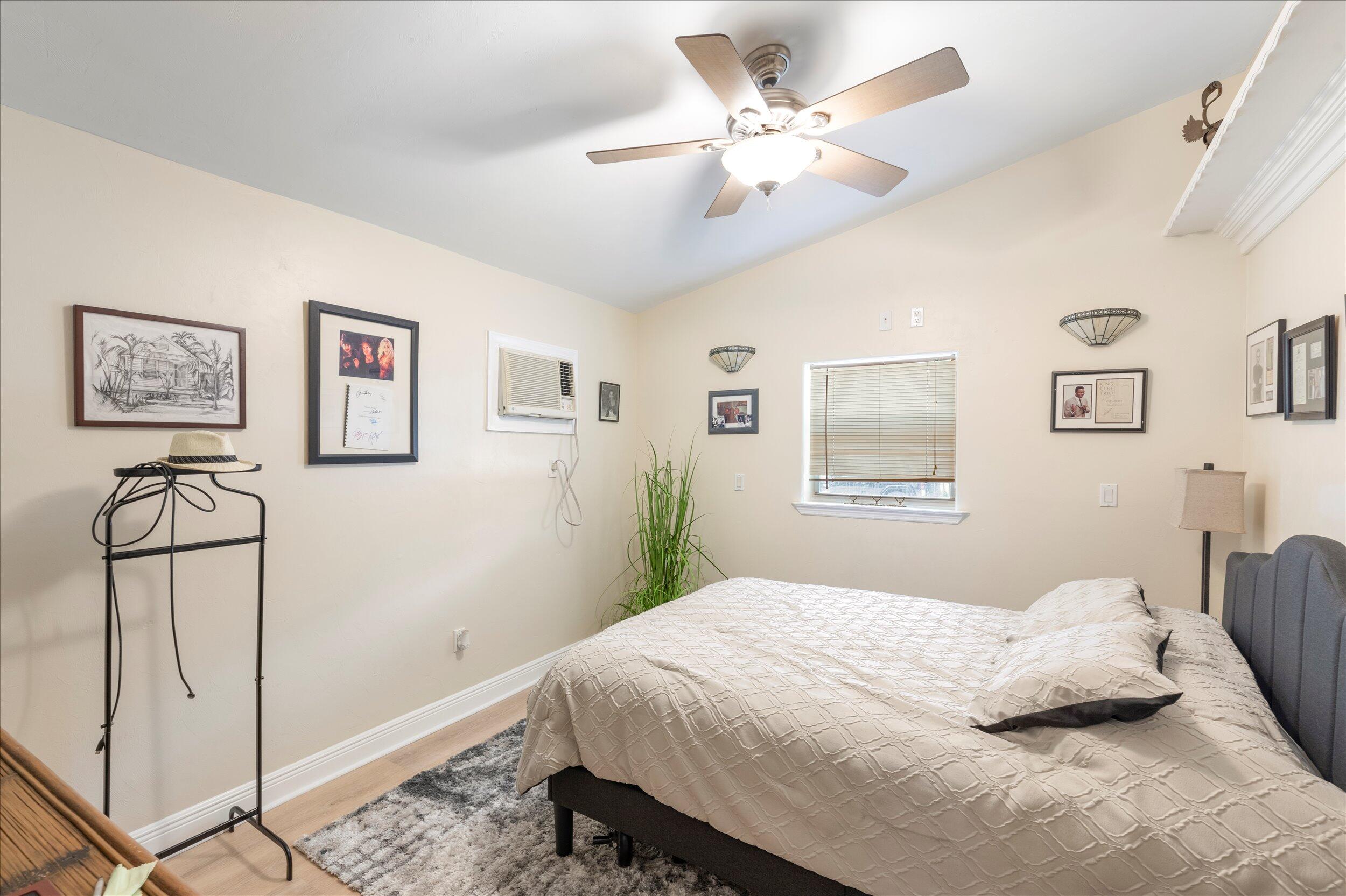 1320 6th Street Key West, FL 33040 - Photo 33 of 61 a bedroom with a large bed and a chandelier