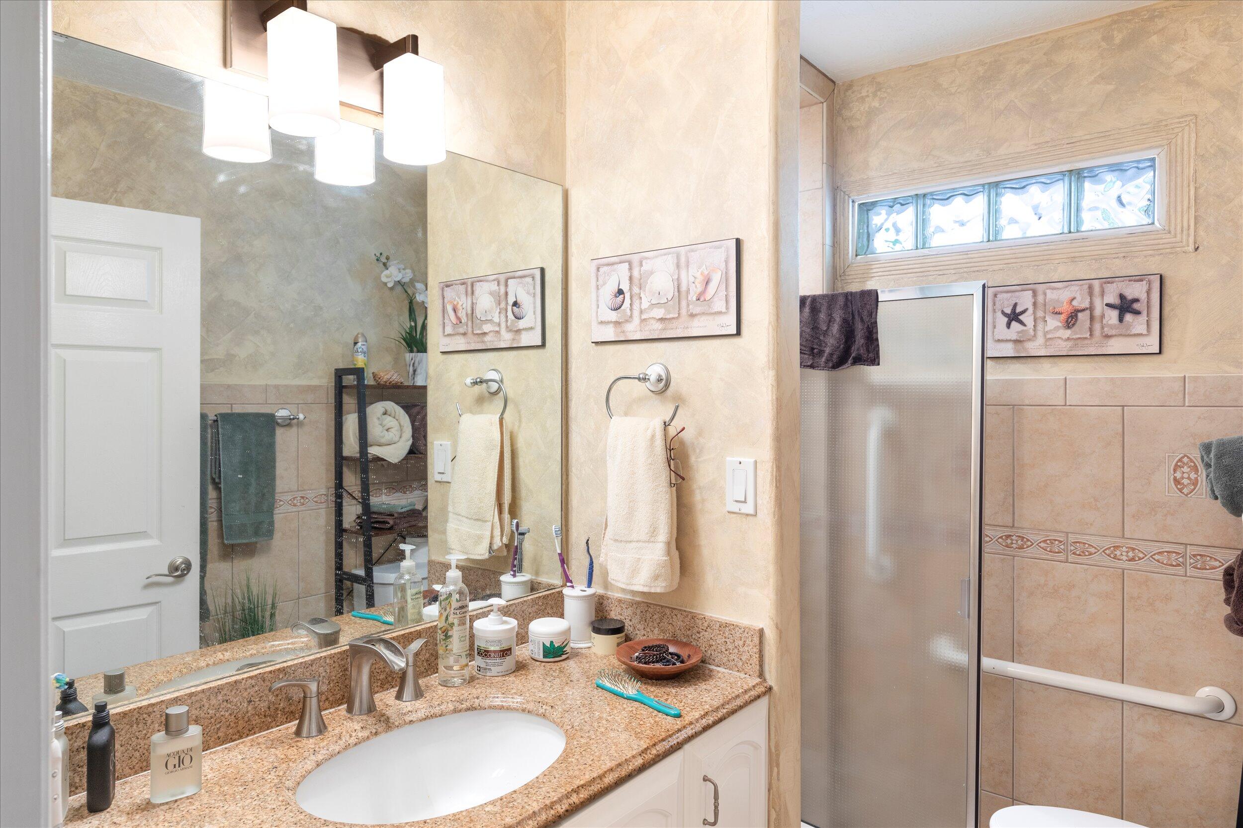 1320 6th Street Key West, FL 33040 - Photo 35 of 61 a bathroom with a granite countertop shower sink and mirror