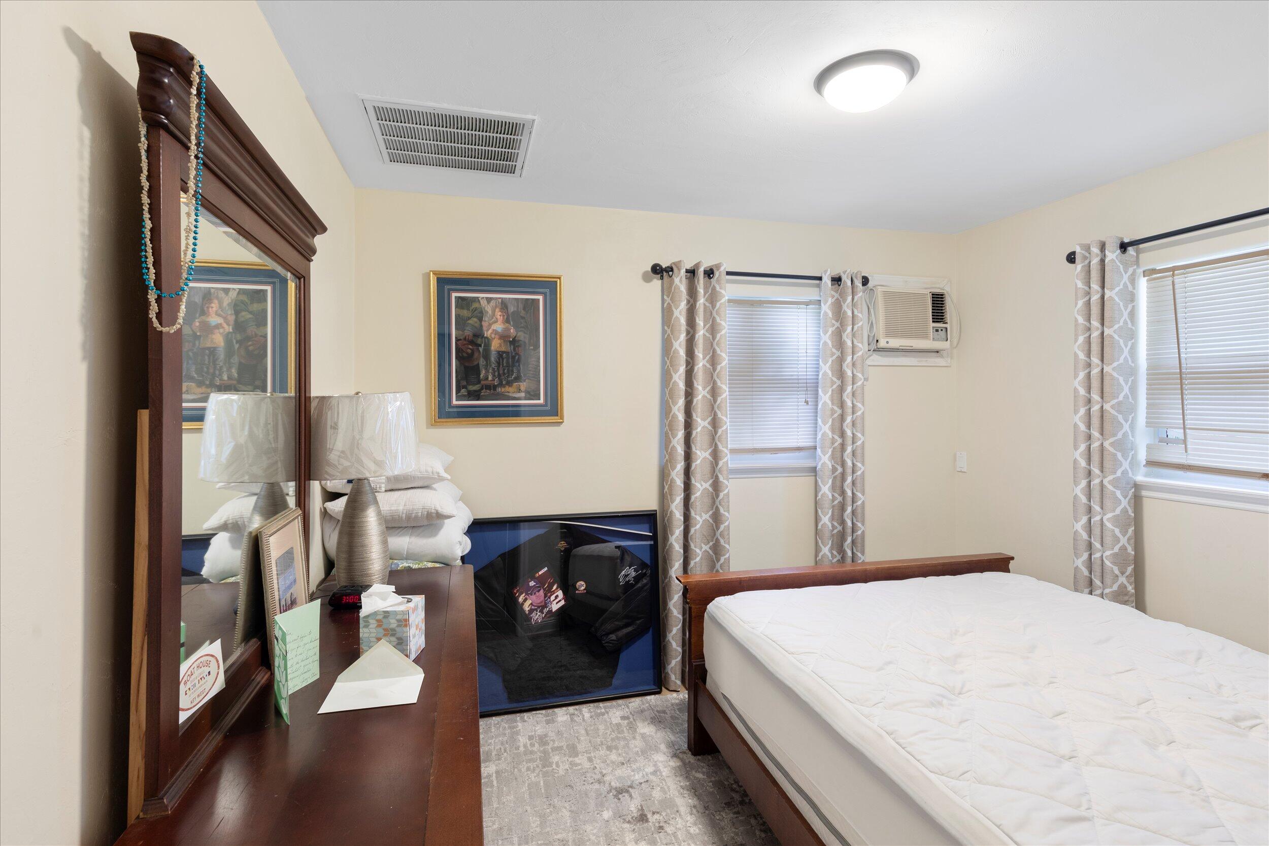 1320 6th Street Key West, FL 33040 - Photo 38 of 61 a bedroom with a bed and a chandelier