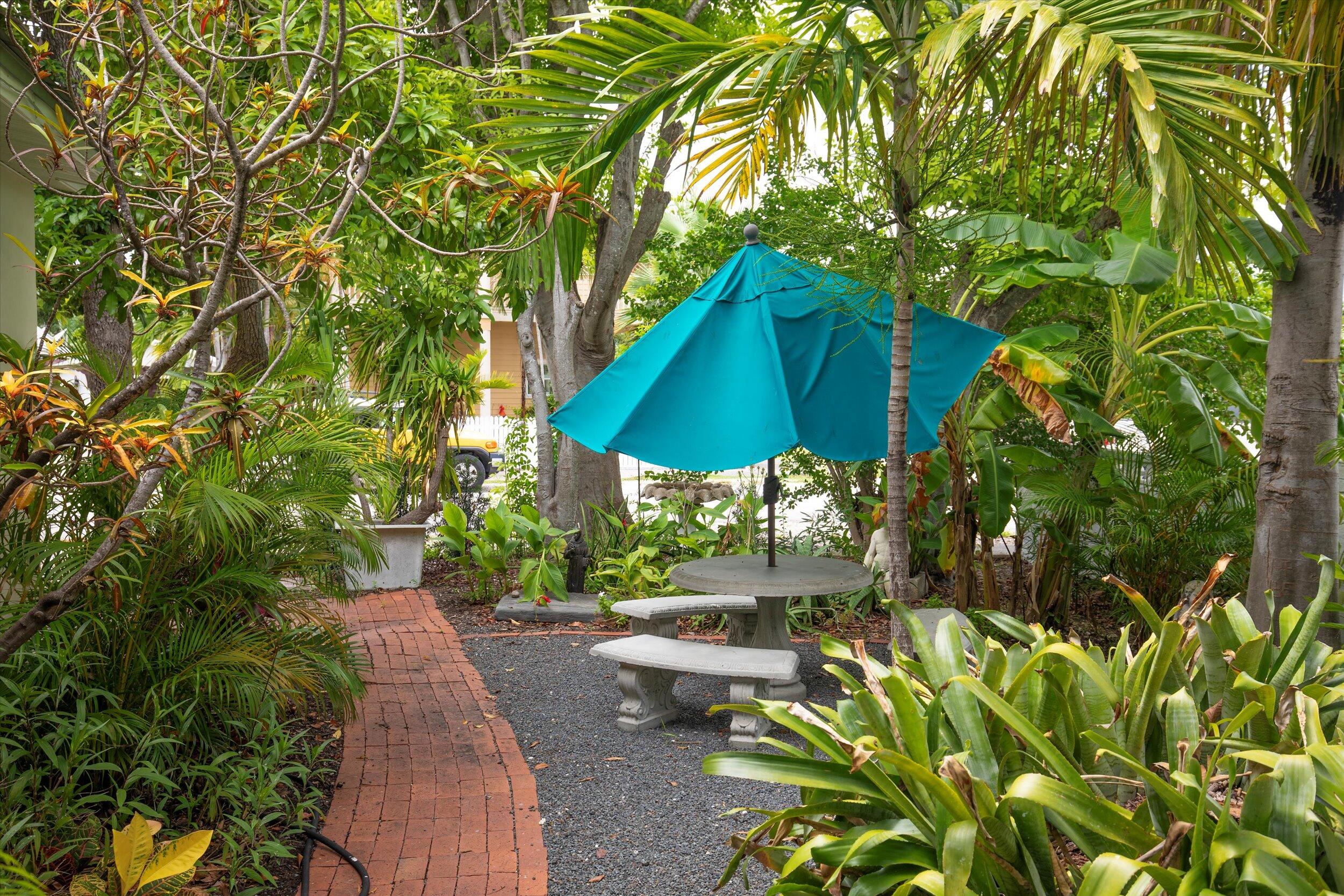 1320 6th Street Key West, FL 33040 - Photo 5 of 61 a view of a patio with table and chairs under an umbrella
