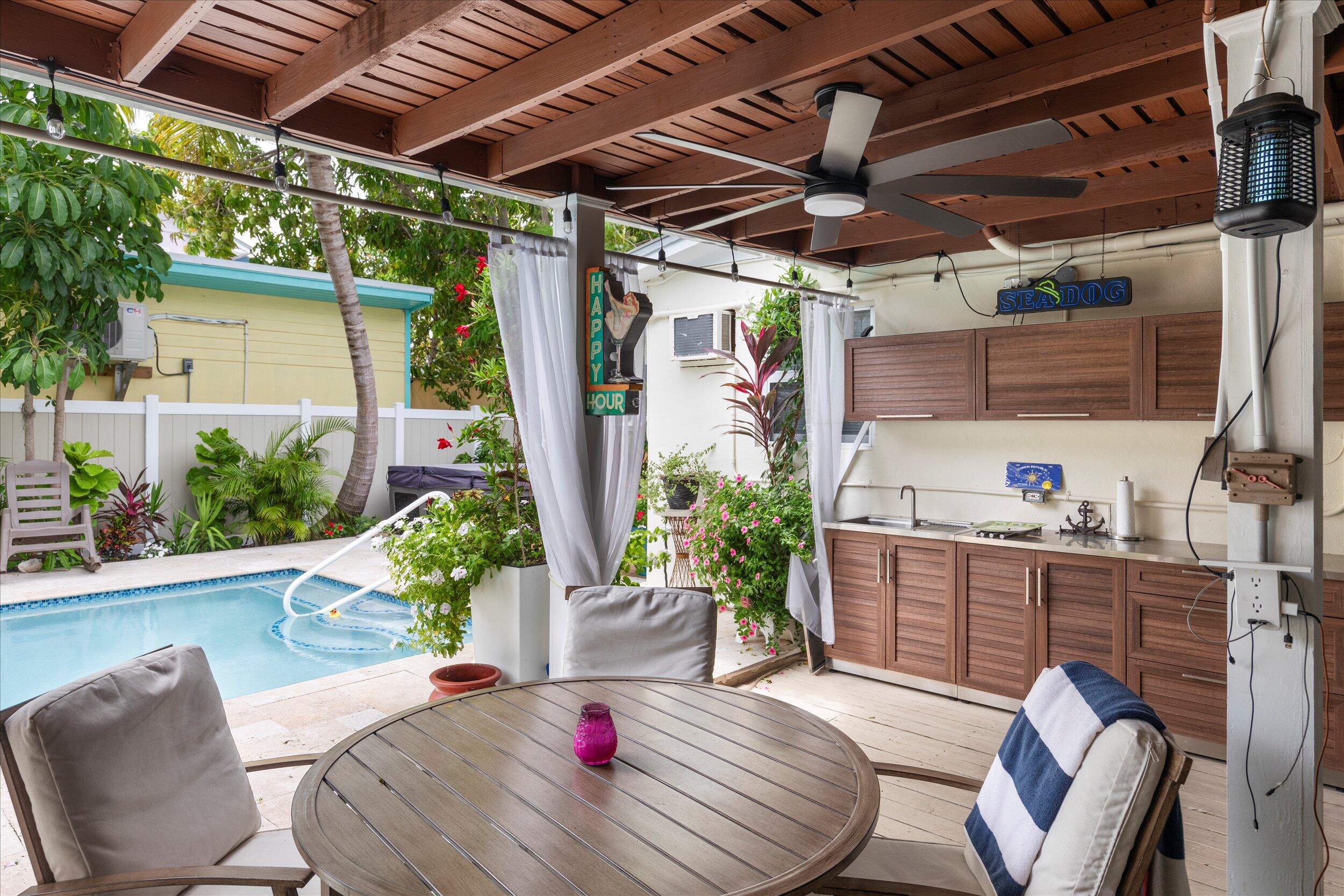 1320 6th Street Key West, FL 33040 - Photo 9 of 61 a view of a porch with furniture and a potted plants