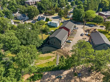 an aerial view of residential houses with outdoor space