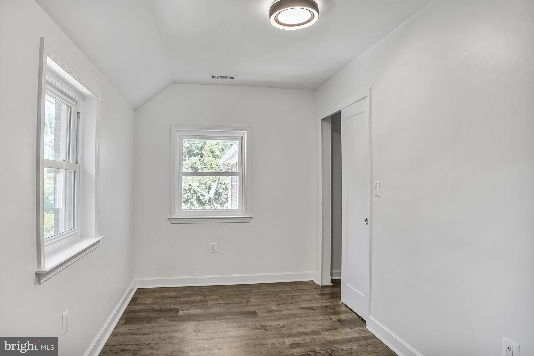 4515 Old Branch Avenue Temple Hills, MD 20748 - Photo 12 of 21 a view of an empty room with wooden floor and a window