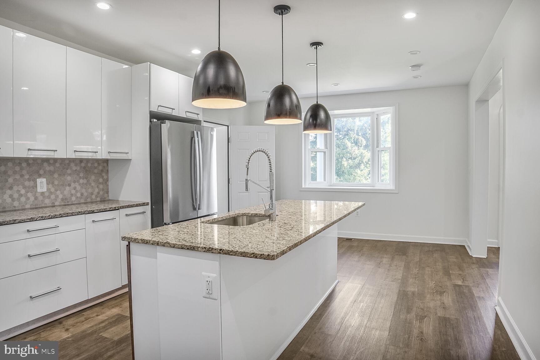 4515 Old Branch Avenue Temple Hills, MD 20748 - Photo 7 of 21 a kitchen with granite countertop a sink a window and stainless steel appliances