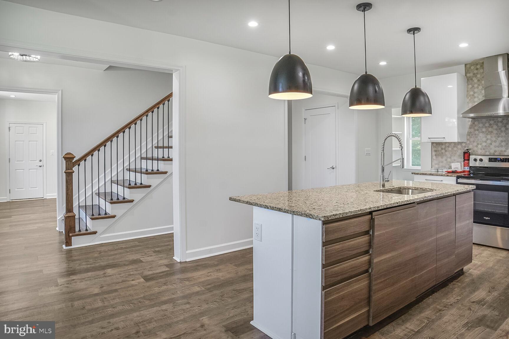 4515 Old Branch Avenue Temple Hills, MD 20748 - Photo 8 of 21 a kitchen with granite countertop a stove a sink a refrigerator and a wooden floor