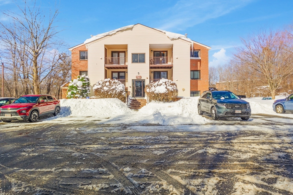 a view of a white house with a yard