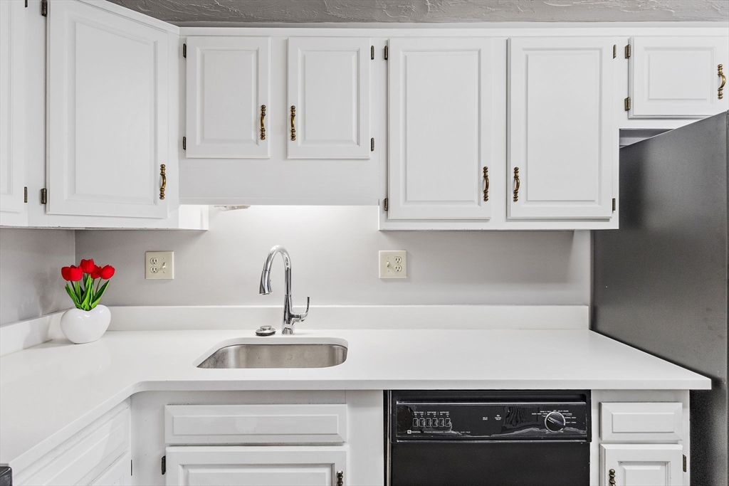 189 Littleton Road, Unit 10 Chelmsford, MA 01824 - Photo 11 of 19 a kitchen with white cabinets and a sink