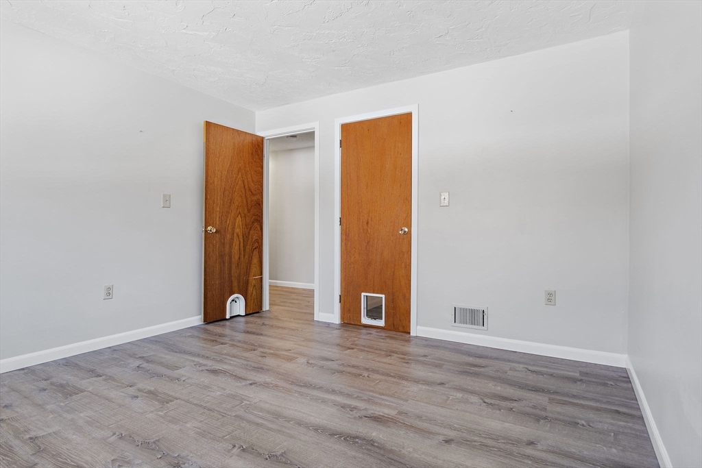 189 Littleton Road, Unit 10 Chelmsford, MA 01824 - Photo 16 of 19 a view of an empty room with wooden floor