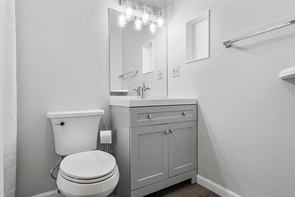 189 Littleton Road, Unit 10 Chelmsford, MA 01824 - Photo 19 of 19 a bathroom with a toilet a sink a vanity and mirror