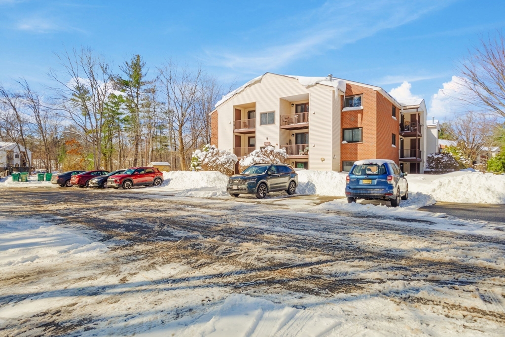 189 Littleton Road, Unit 10 Chelmsford, MA 01824 - Photo 3 of 19 a view of a parked cars in front of a building