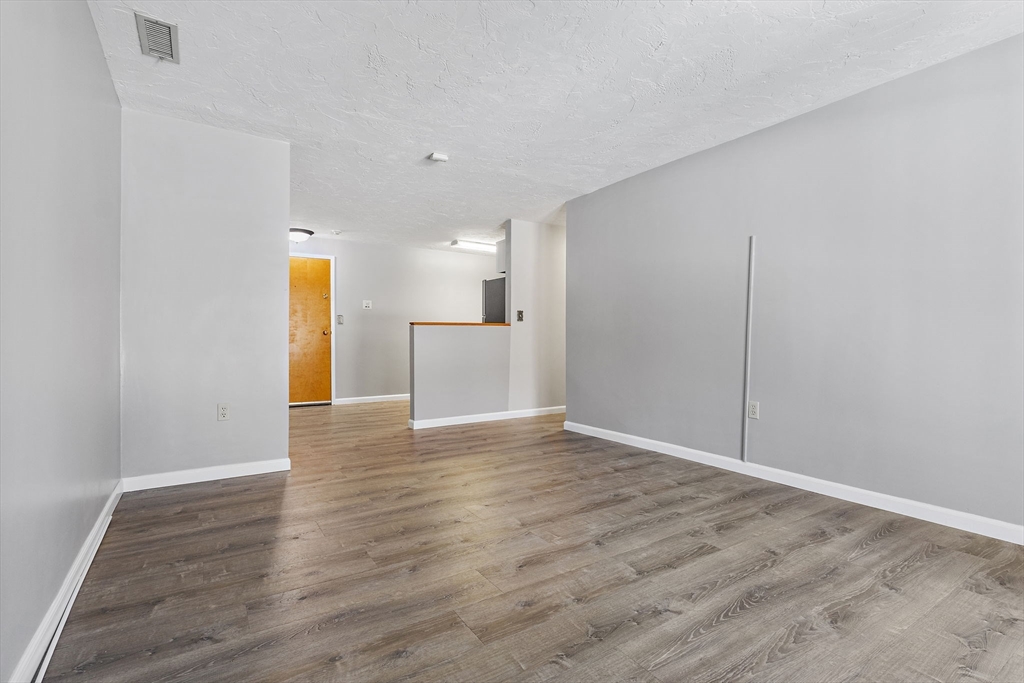 189 Littleton Road, Unit 10 Chelmsford, MA 01824 - Photo 7 of 19 a view of a kitchen with a sink and a refrigerator