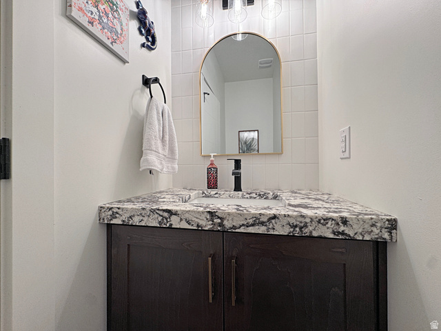 851 Grandview Drive Morgan, UT 84050 - Photo 30 of 68 Bathroom vanity with a dark wood-finish cabinet, speckled stone countertop, and integrated sink