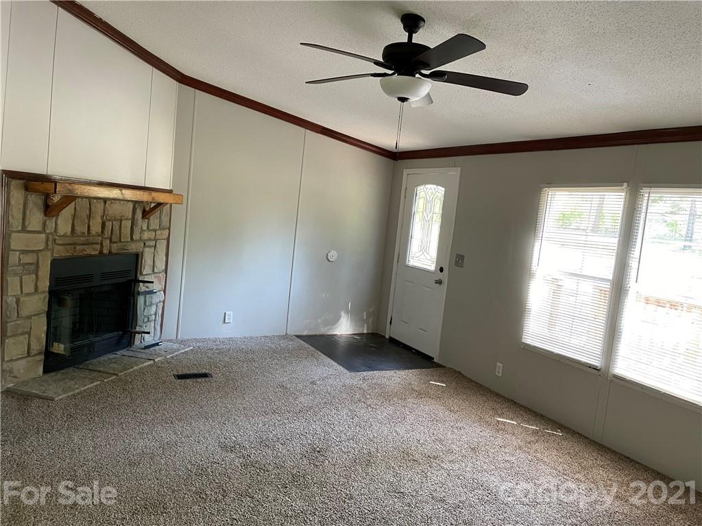 4794 Blade Run Road Edgemoor, SC 29712 - Photo 12 of 20 a view of an empty room with a fireplace and a window