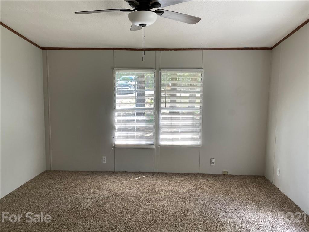 4794 Blade Run Road Edgemoor, SC 29712 - Photo 13 of 20 a view of a livingroom with a ceiling fan and window