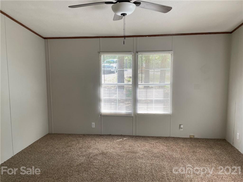 4794 Blade Run Road Edgemoor, SC 29712 - Photo 17 of 20 a view of a livingroom with a ceiling fan and window