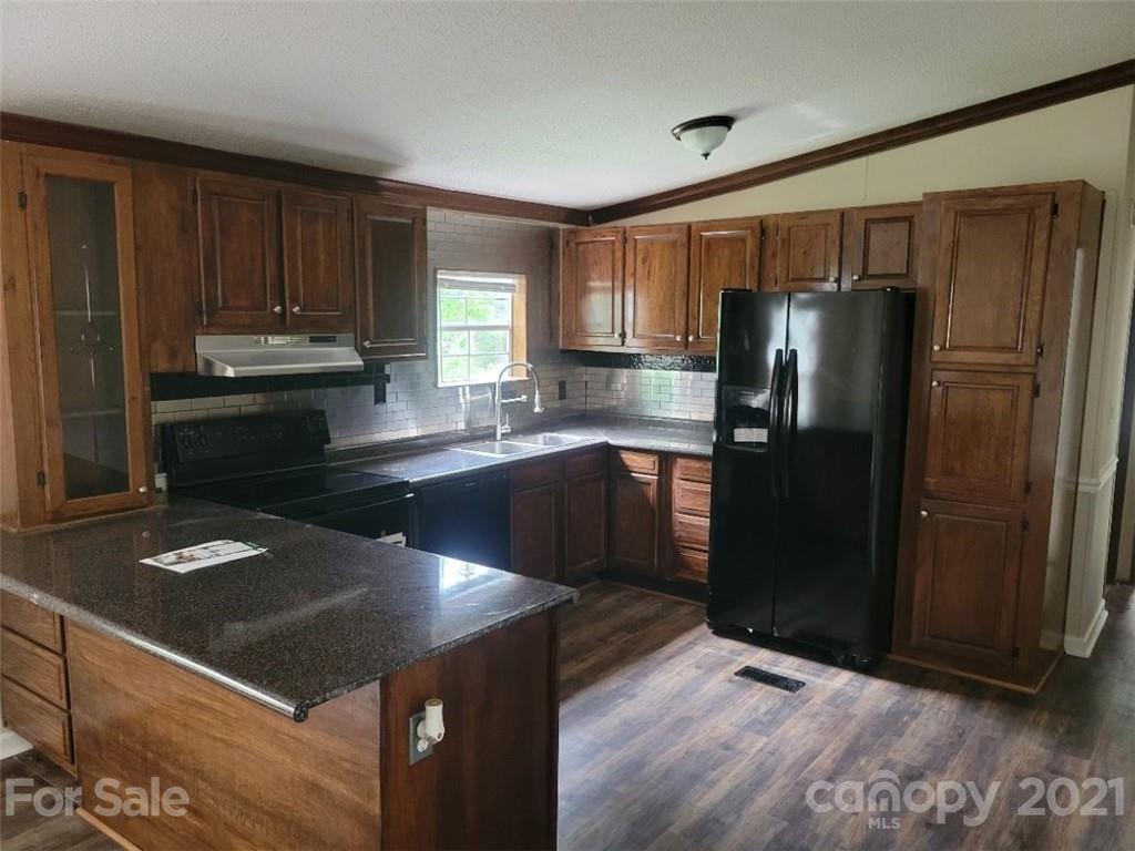4794 Blade Run Road Edgemoor, SC 29712 - Photo 9 of 20 a kitchen with granite countertop stainless steel appliances and wooden cabinets