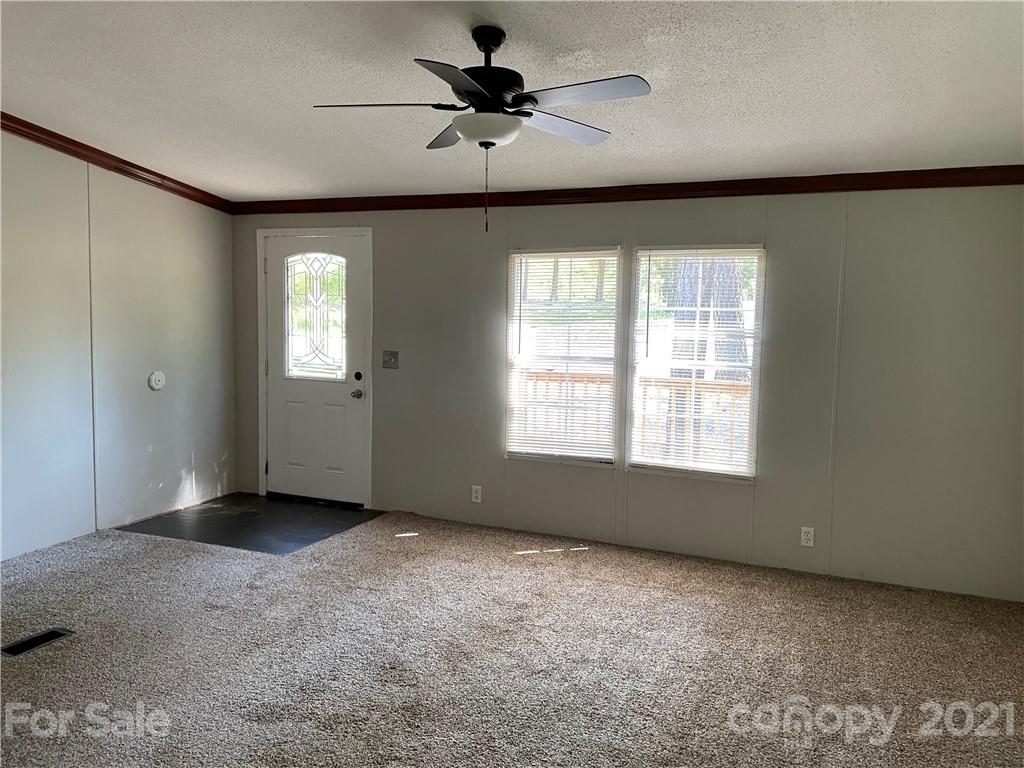 4794 Blade Run Road Edgemoor, SC 29712 - Photo 10 of 20 a view of a livingroom with a ceiling fan and window
