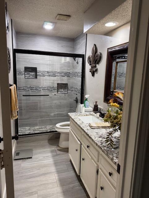 4806 76th Street Lubbock, TX 79424 - Photo 4 of 11 a bathroom with a granite countertop sink a toilet and shower