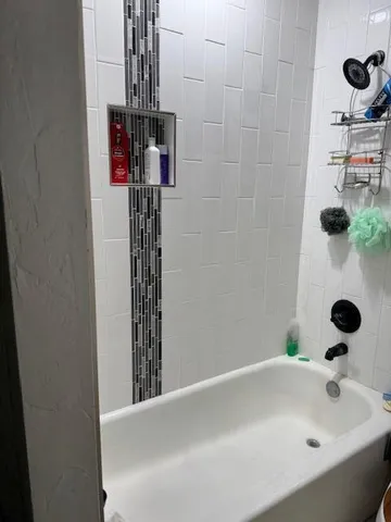 a bathroom with a bathtub and shower