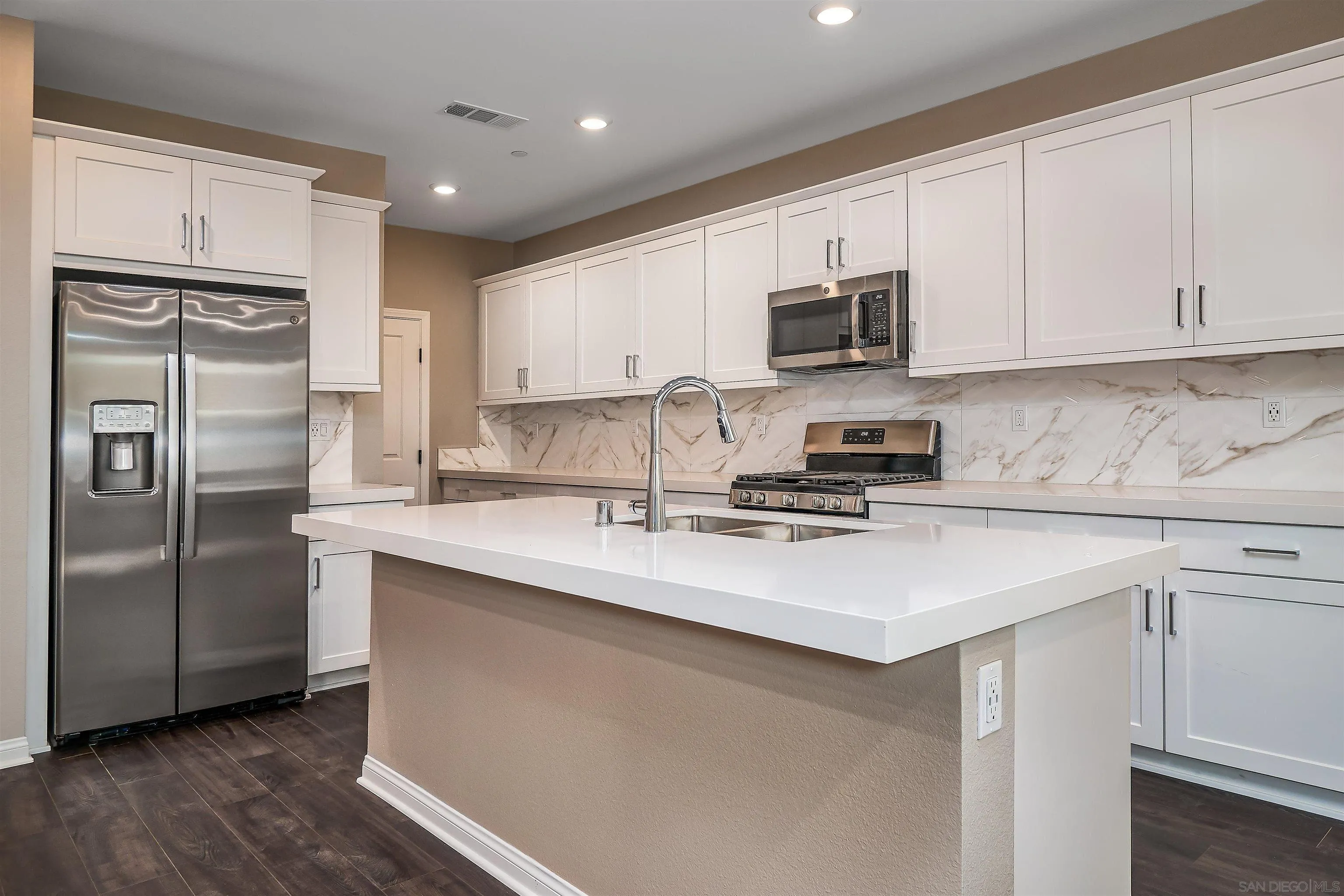 1790 Whitmore Loop Chula Vista, CA 91913 - Photo 2 of 28 a kitchen with stainless steel appliances granite countertop a sink stove refrigerator and cabinets