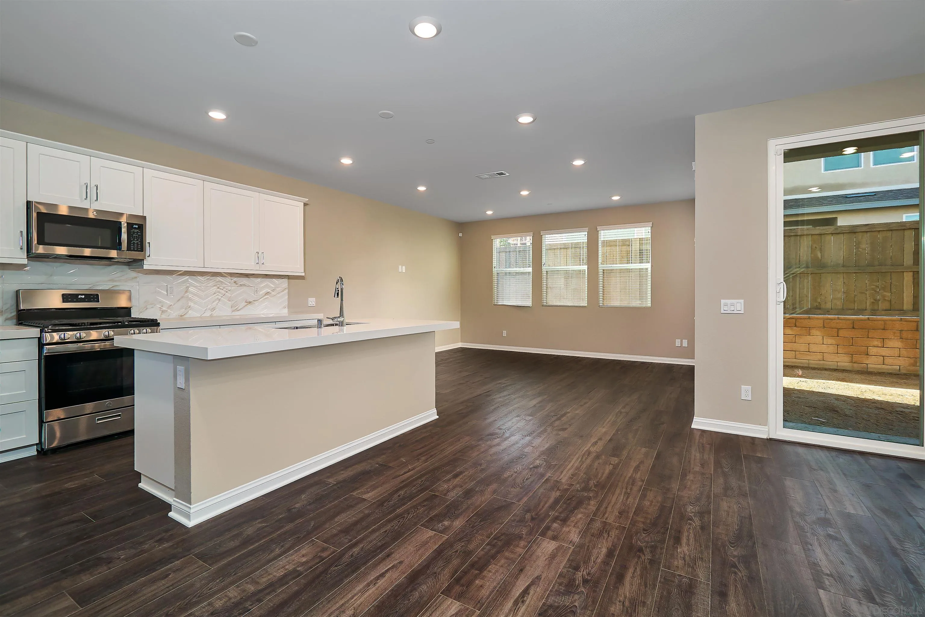1790 Whitmore Loop Chula Vista, CA 91913 - Photo 22 of 28 a kitchen with stainless steel appliances granite countertop a stove a sink and a microwave