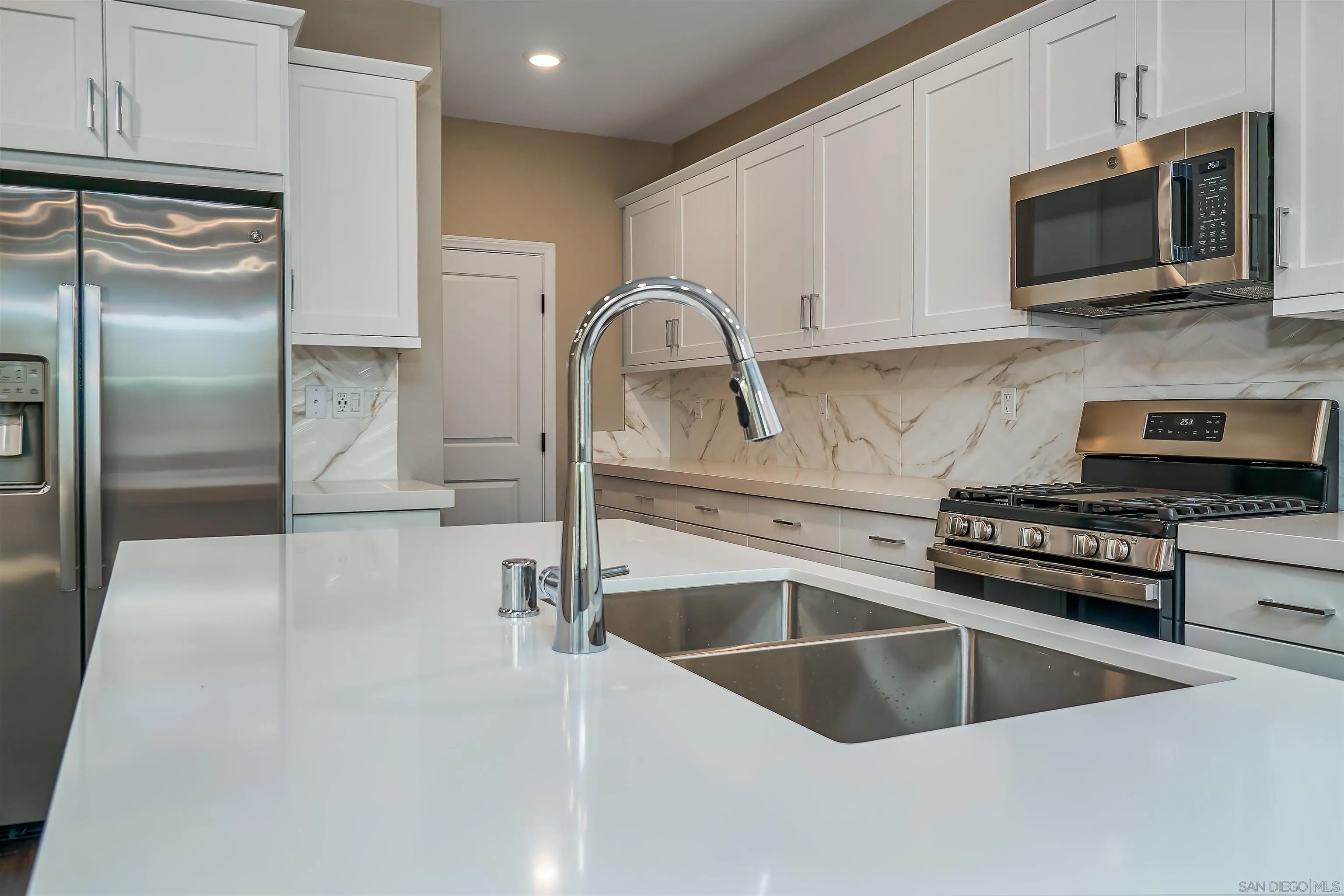 1790 Whitmore Loop Chula Vista, CA 91913 - Photo 24 of 28 a kitchen with a refrigerator stove and microwave