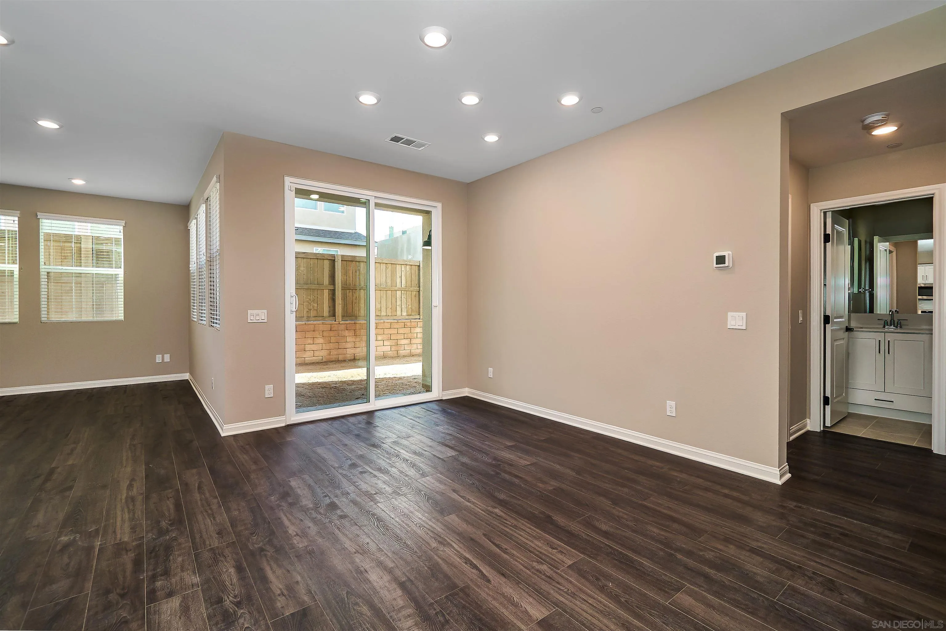 1790 Whitmore Loop Chula Vista, CA 91913 - Photo 28 of 28 an empty room with wooden floor and windows