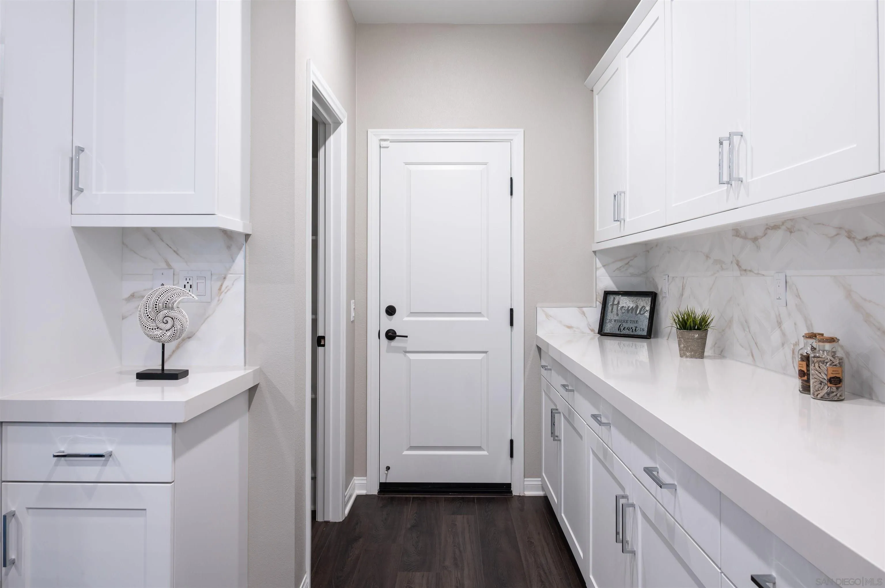 1790 Whitmore Loop Chula Vista, CA 91913 - Photo 3 of 28 a kitchen with white cabinets and sink