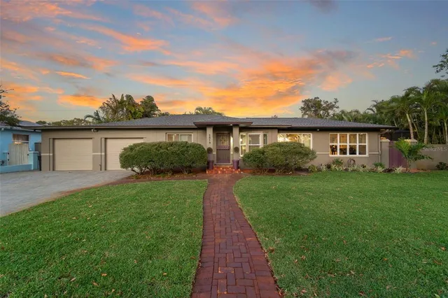 a living room with patio furniture and a floor to ceiling window