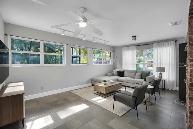 a living room with furniture and a large window
