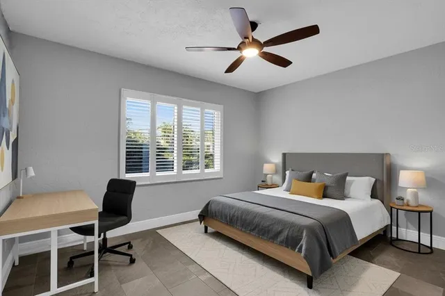 a bedroom with a bed window and a desk